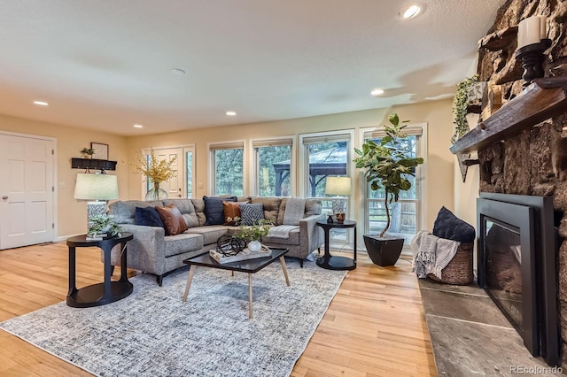 26732 Main St, Conifer, CO 80433 - living room featuring a large fireplace, wood finished floors, and recessed lighting