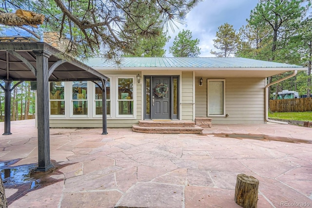26732 Main St, Conifer, CO 80433 - view of front of house featuring a metal roof and a patio
