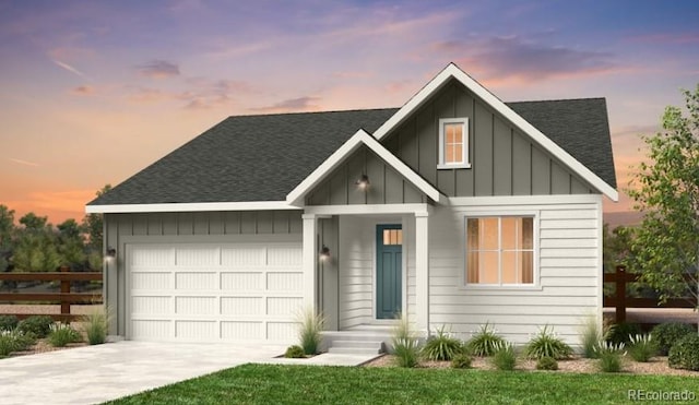 view of front of property with a garage and a yard