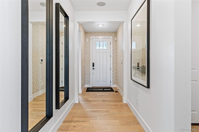 corridor with light hardwood / wood-style flooring