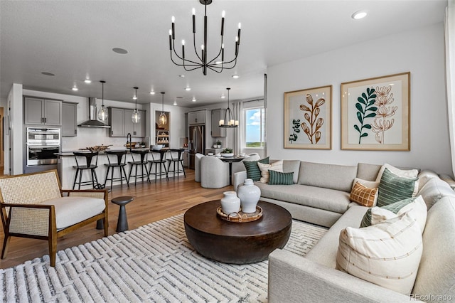 living room featuring light hardwood / wood-style floors and an inviting chandelier