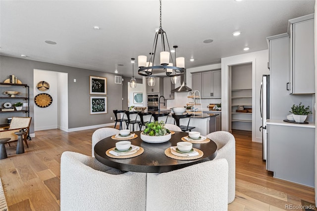 dining area with light wood-type flooring and sink