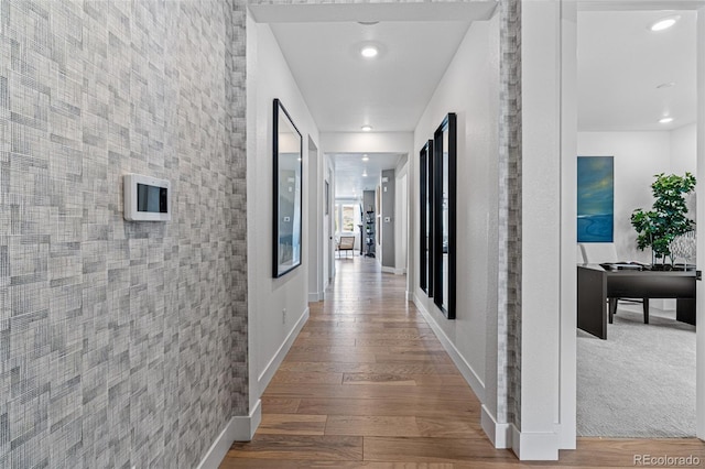 hallway with hardwood / wood-style floors