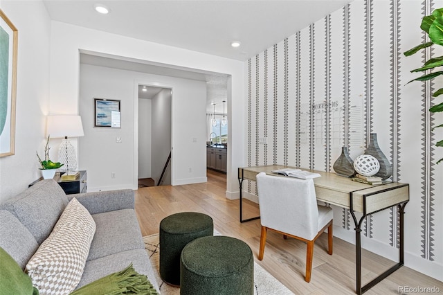 office featuring hardwood / wood-style flooring and sink