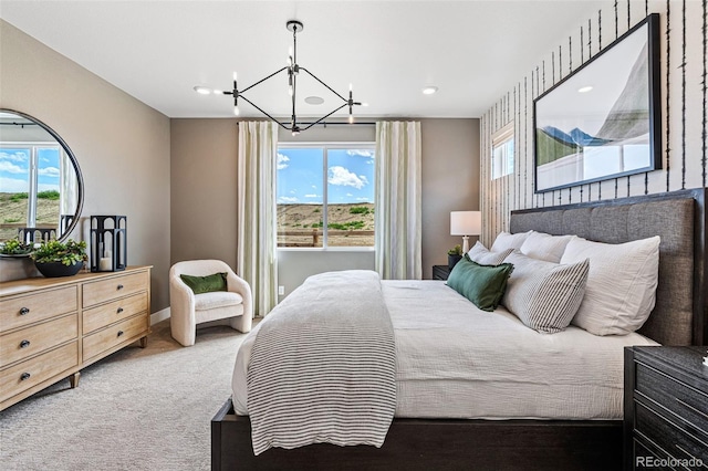 carpeted bedroom featuring multiple windows and an inviting chandelier