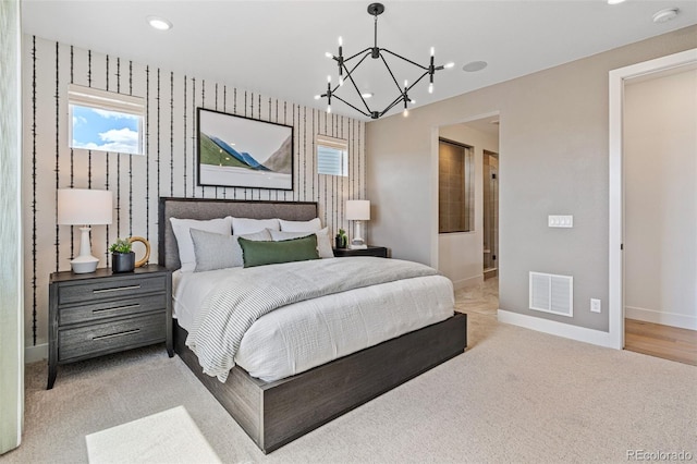 carpeted bedroom featuring an inviting chandelier