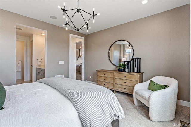 carpeted bedroom featuring ensuite bathroom and an inviting chandelier