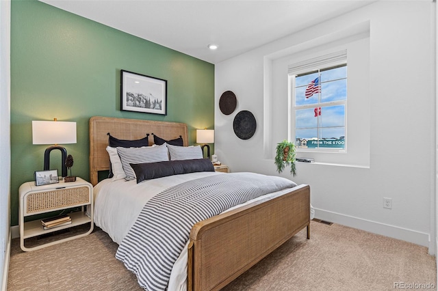 bedroom featuring light carpet