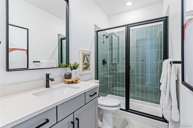 bathroom with tile patterned floors, toilet, vanity, and walk in shower