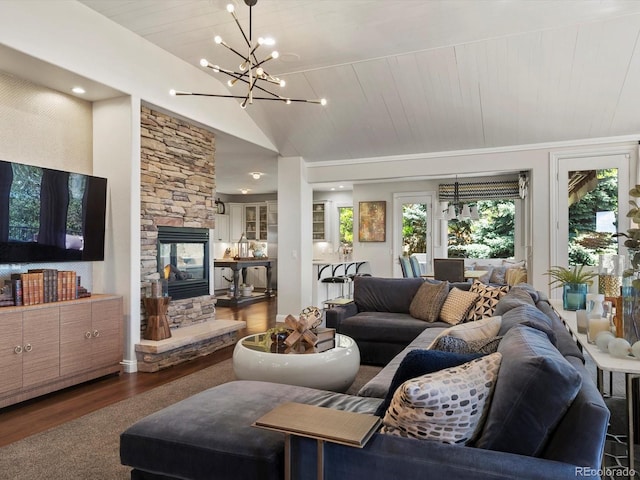 6405 Warriors Run, Littleton, CO 80125 - living area featuring wood finished floors, lofted ceiling, a chandelier, and a stone fireplace