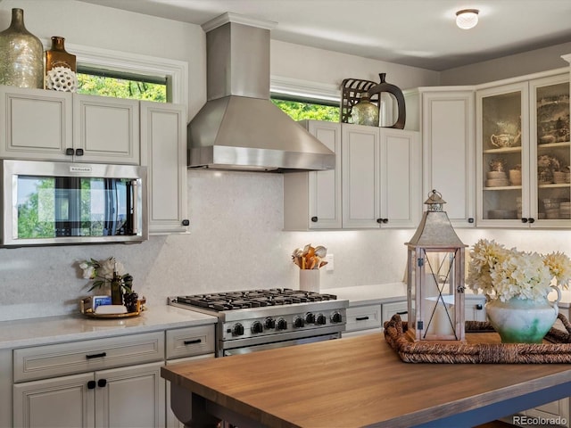 6405 Warriors Run, Littleton, CO 80125 - kitchen with wood counters, extractor fan, appliances with stainless steel finishes, and healthy amount of natural light