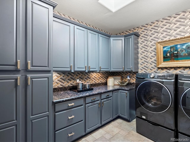 6405 Warriors Run, Littleton, CO 80125 - laundry room featuring washer and dryer, cabinet space, and light stone finish flooring