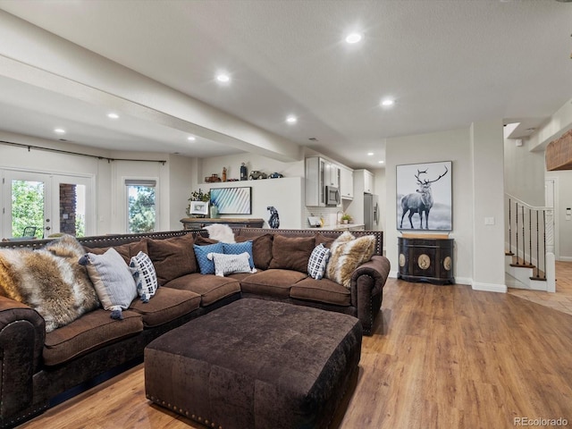 6405 Warriors Run, Littleton, CO 80125 - living area with light wood finished floors, recessed lighting, stairs, french doors, and baseboards