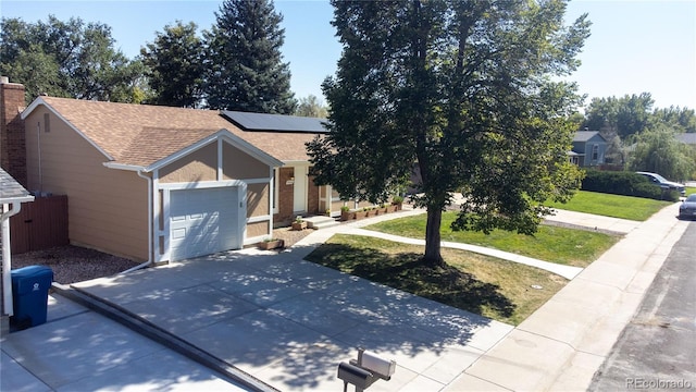 view of front of home featuring a garage and a front lawn