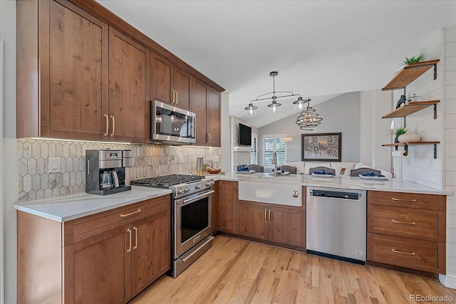 kitchen with tasteful backsplash, open shelves, a sink, vaulted ceiling, and stainless steel appliances