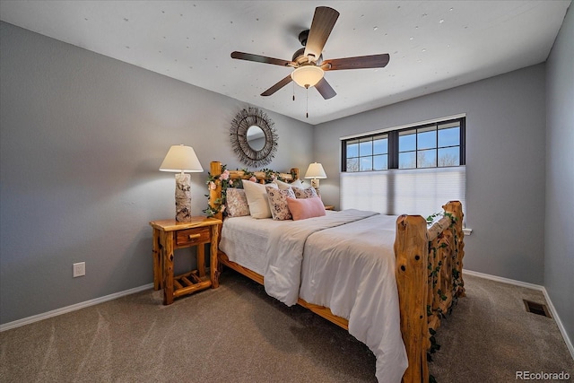 carpeted bedroom featuring baseboards, a ceiling fan, and visible vents