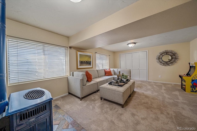 living area featuring light colored carpet and baseboards