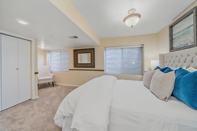 carpeted bedroom featuring visible vents and baseboards