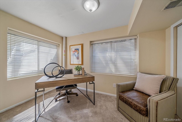 carpeted office space with baseboards and visible vents