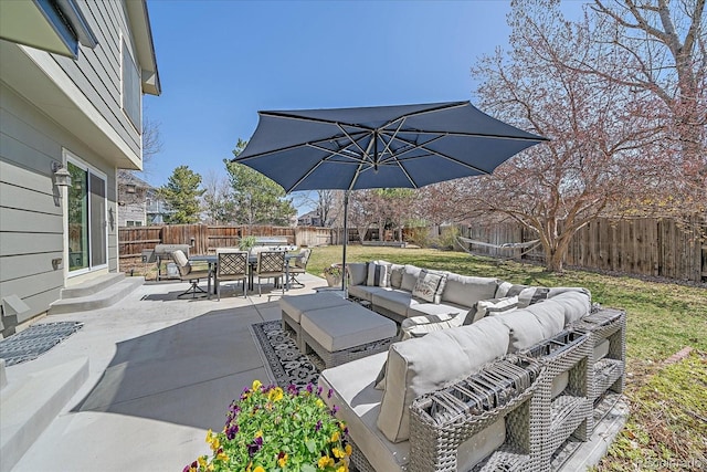view of patio / terrace with entry steps, a fenced backyard, an outdoor living space, and outdoor dining space