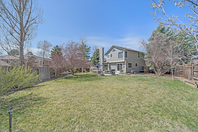 view of yard with a fenced backyard and a patio