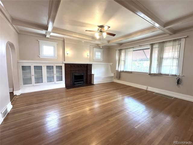519 Broadway, Pueblo, CO 81004 - unfurnished living room with ceiling fan, coffered ceiling, plenty of natural light, a brick fireplace, and wood finished floors