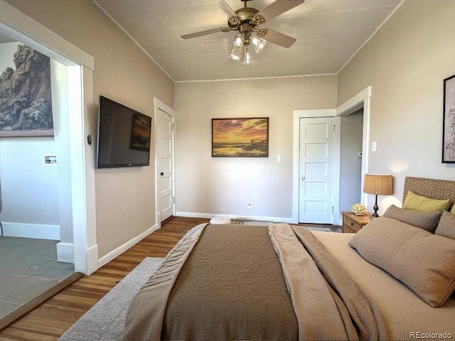 bedroom featuring hardwood / wood-style flooring and ceiling fan