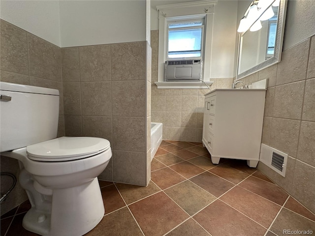 519 Broadway, Pueblo, CO 81004 - bathroom featuring tile walls, a bath, vanity, tile patterned floors, and cooling unit