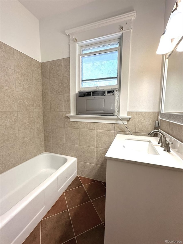 bathroom with vanity, a bath, cooling unit, tile patterned flooring, and tile walls