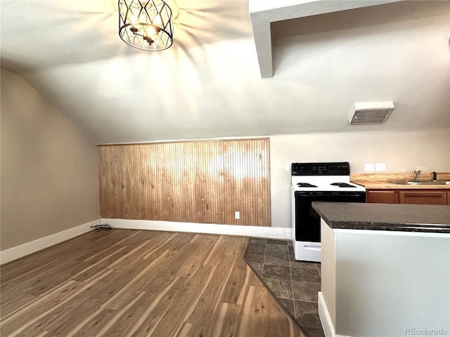 kitchen with white range with electric stovetop, lofted ceiling, sink, and dark hardwood / wood-style floors