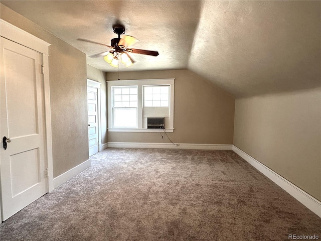 bonus room featuring carpet flooring, ceiling fan, lofted ceiling, and a textured ceiling