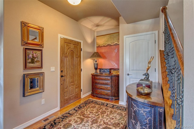 foyer entrance with hardwood / wood-style flooring