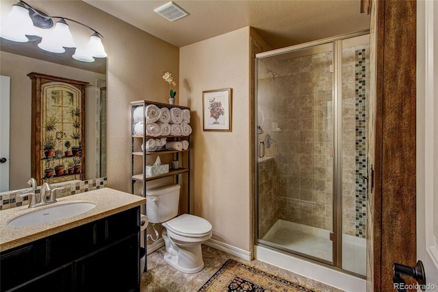 bathroom featuring toilet, an enclosed shower, and vanity