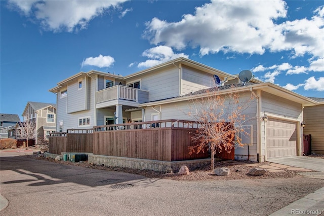 exterior space with a balcony and a garage