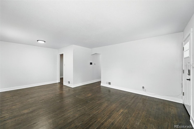 1941 Alton St, Aurora, CO 80010 - unfurnished living room with dark wood-style flooring and baseboards