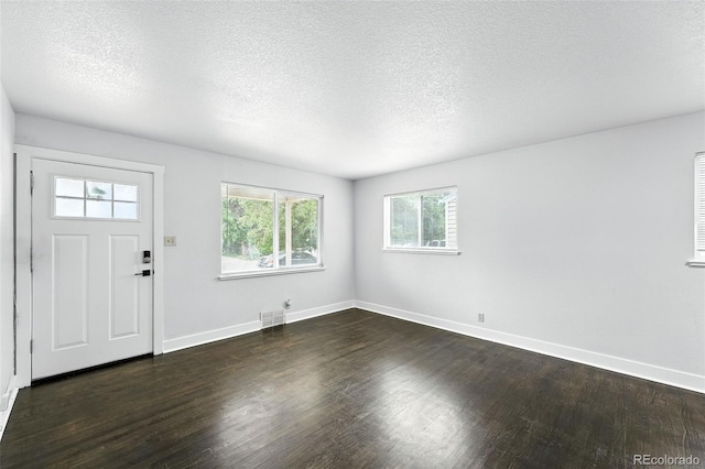 1941 Alton St, Aurora, CO 80010 - entrance foyer with dark wood-type flooring and a textured ceiling