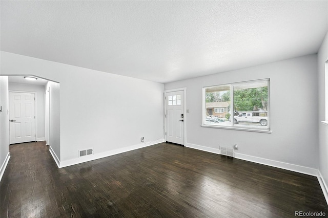 1941 Alton St, Aurora, CO 80010 - entryway featuring wood finished floors, arched walkways, and a textured ceiling