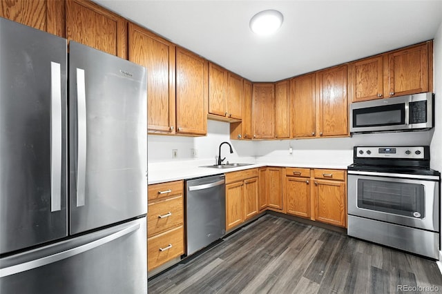 1941 Alton St, Aurora, CO 80010 - kitchen with stainless steel appliances, dark wood-type flooring, light countertops, and brown cabinetry