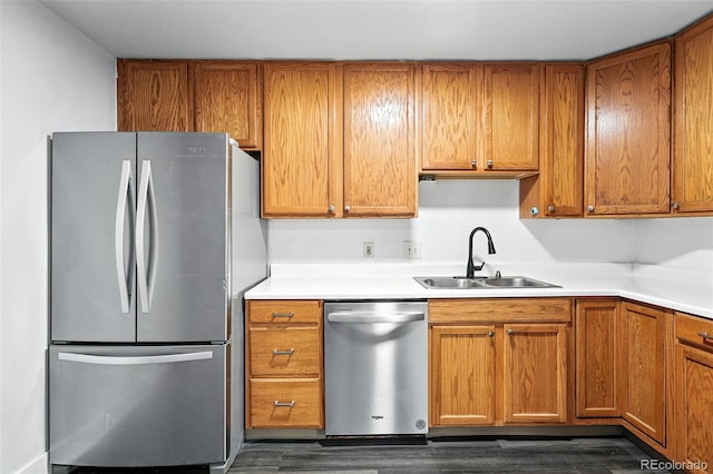 1941 Alton St, Aurora, CO 80010 - kitchen with appliances with stainless steel finishes, dark wood-style floors, brown cabinetry, and light countertops