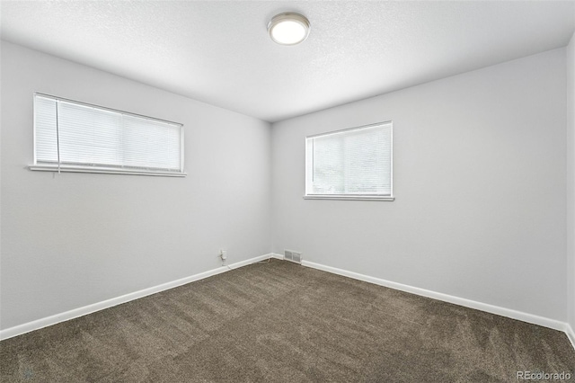 1941 Alton St, Aurora, CO 80010 - empty room with dark carpet and baseboards