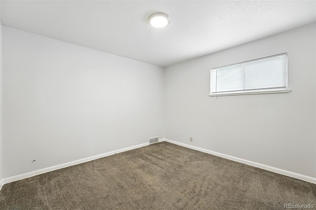 1941 Alton St, Aurora, CO 80010 - spare room featuring dark carpet and baseboards