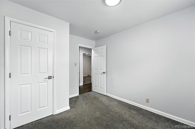 1941 Alton St, Aurora, CO 80010 - unfurnished bedroom with dark colored carpet and baseboards