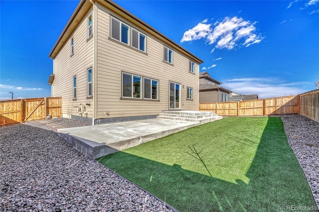 rear view of property with a patio area, a fenced backyard, a gate, and a lawn