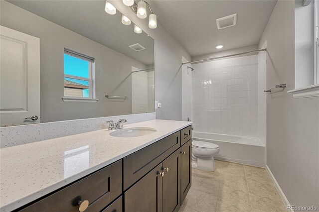 bathroom with toilet, vanity, visible vents, and baseboards