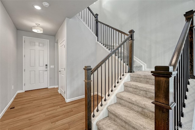 entryway featuring light wood finished floors, recessed lighting, visible vents, stairway, and baseboards