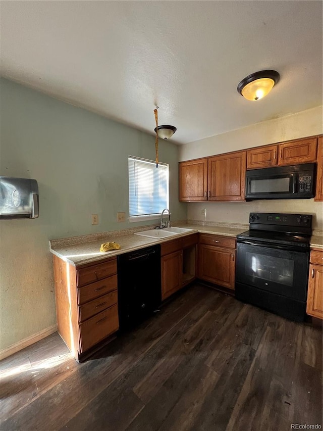 kitchen featuring dark hardwood / wood-style flooring, sink, and black appliances