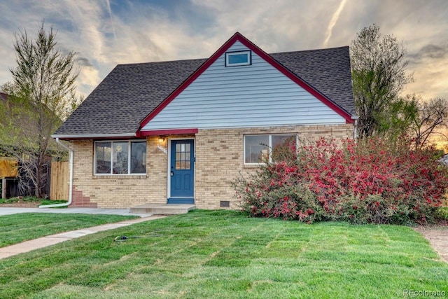 bungalow-style house featuring brick siding, crawl space, and a front yard