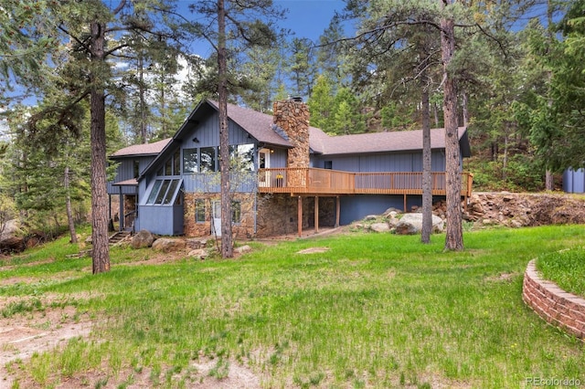 4835 Abo Ln, Monument, CO 80132 - back of house featuring a deck, a chimney, stone siding, a shingled roof, and a yard
