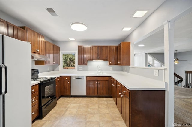 4835 Abo Ln, Monument, CO 80132 - kitchen with stainless steel dishwasher, black / electric stove, freestanding refrigerator, a sink, and under cabinet range hood