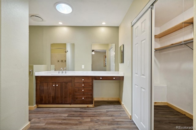 4835 Abo Ln, Monument, CO 80132 - bathroom featuring wood finished floors, double vanity, and baseboards
